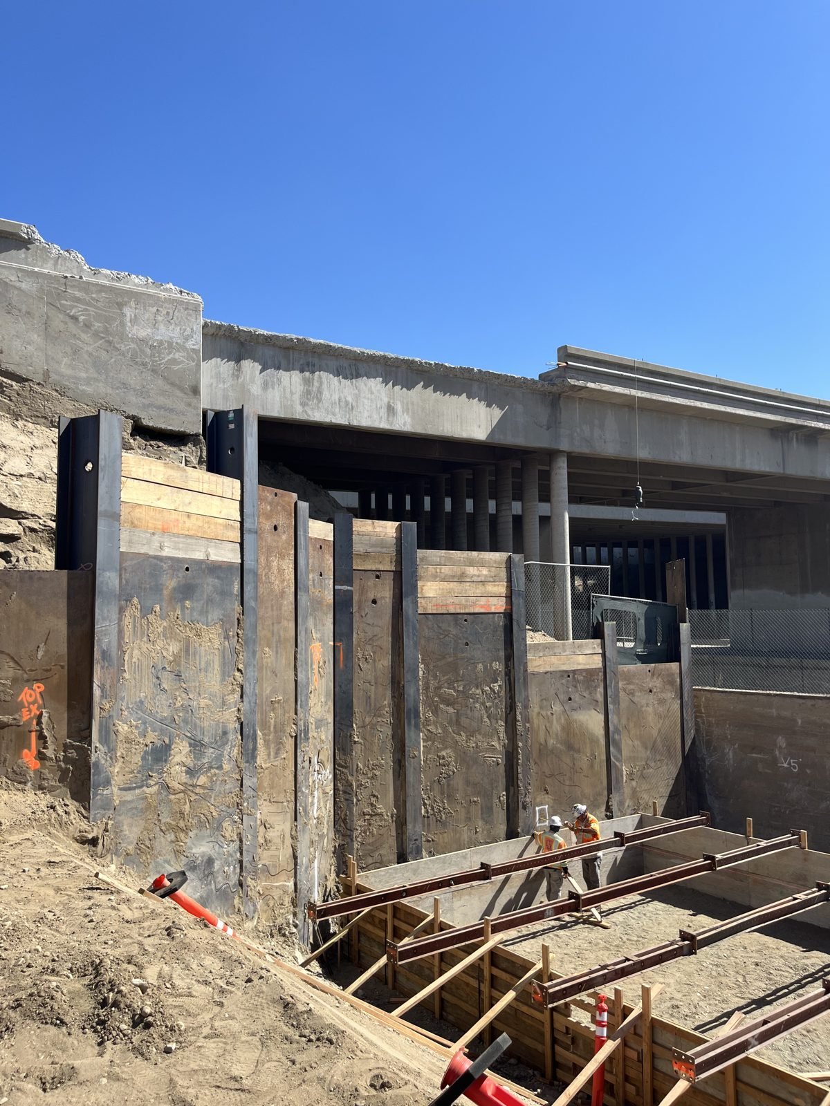 Soldier pile and lagging shoring at a bridge abutment under an existing freeway structure