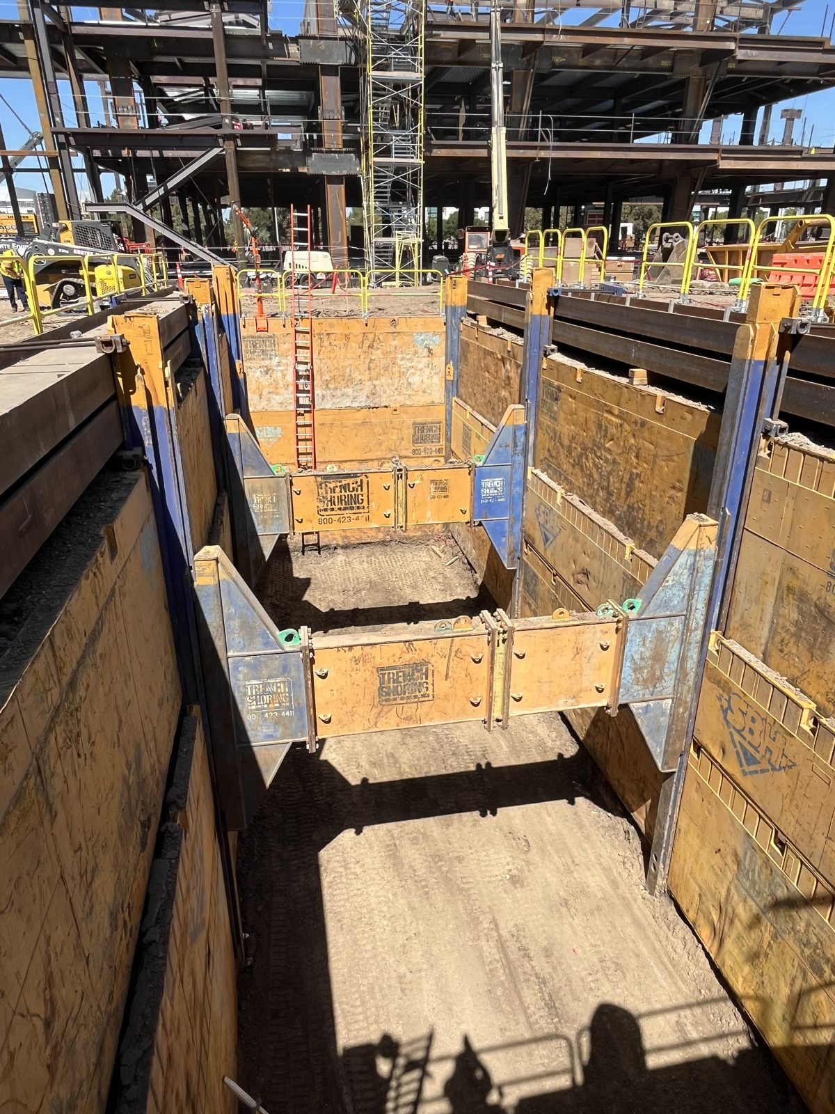 Slide rail shoring system in a deep excavation beside a new steel-frame hospital building